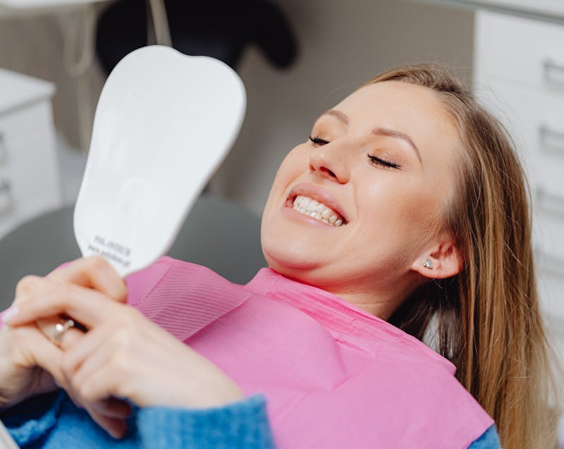 looking at teeth in the mirror