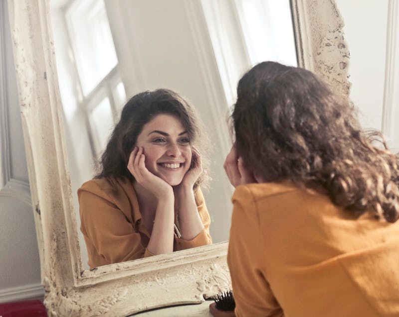 a woman smiling in the mirror